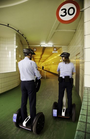 Police driving  through the Maas tunnel on Segways, Rotterdam