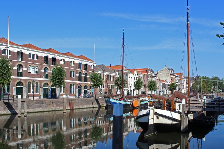 The west quay of the Voorhaven in historical Delfshaven. On the right the sailing ships and on the left the former factory of Henkes, build round 1860. Previously, this was a distillery of gin; now there are located shops, appartments and a bar and restaurant.