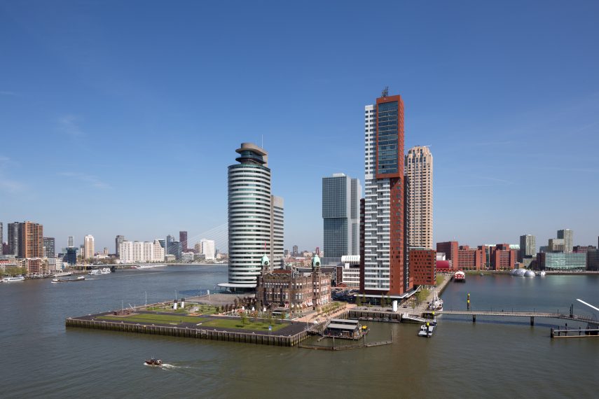 View on the Wilhelminapier in the south. In front the Hotel New York, former office of the Holland America Line. Behind on the left the World Port Center, and on the right the tower Montevideo. In the middle a glimpse of The Rotterdam.