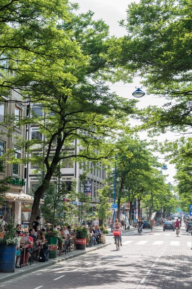 Een zomerse dag in de Witte de Withstraat. Het is een levendige straat, met winkels, galeries, restaurants en cafés.