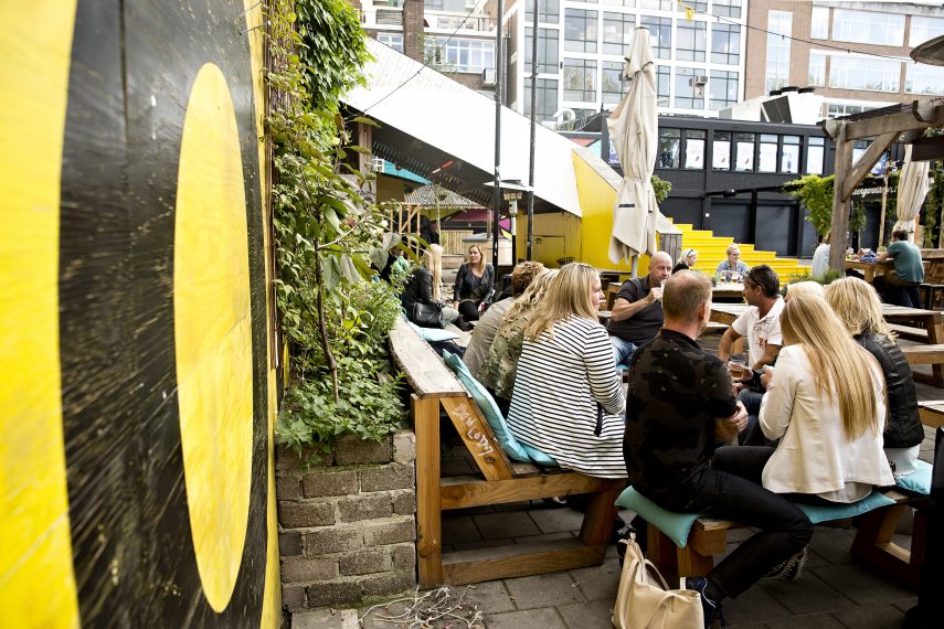 People sitting at the terrace of Biergarten, nearby the Luchtsingel.