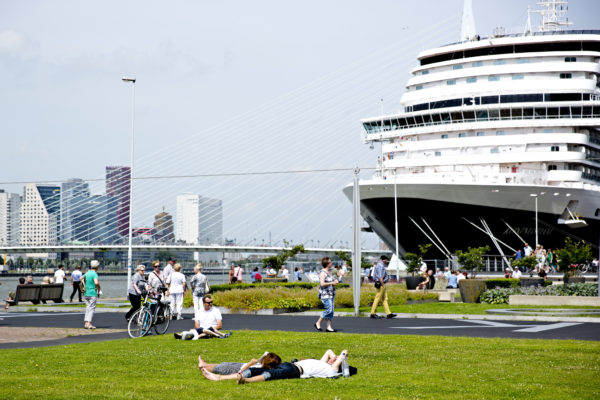 Summertime at quay near Hotel New York, cruise ship Holland America Line and Erasmusbridge in background