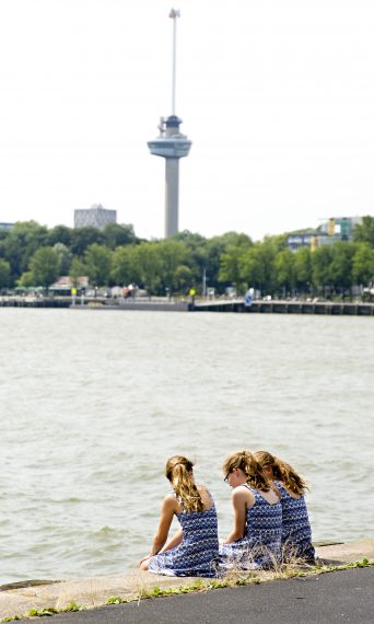 Girls sitting at the quay, Euromast in background