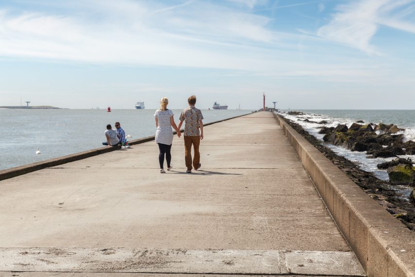 Young couple walking along the Hoek van Holland pier