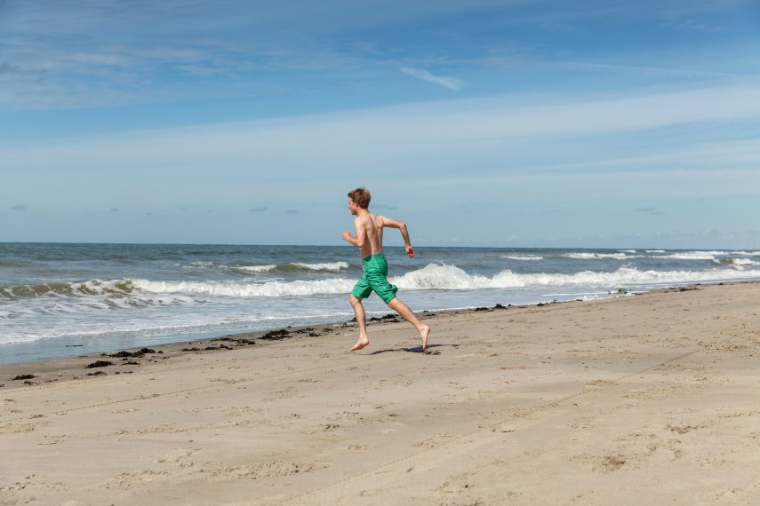 Young man runs towards the sea (Hoek van Holland beach)