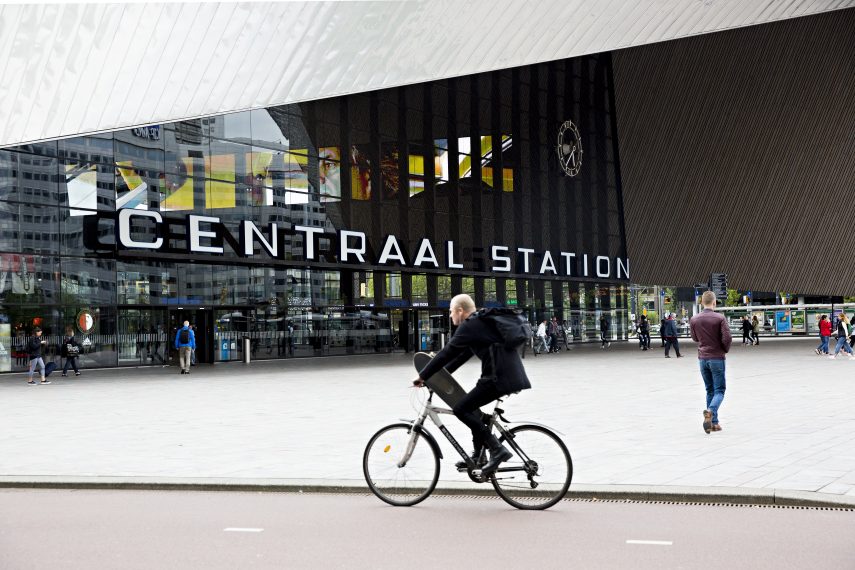 Cyclist crossing Rotterdam Centraal Station designed by Benthem Crouwel Architekten.