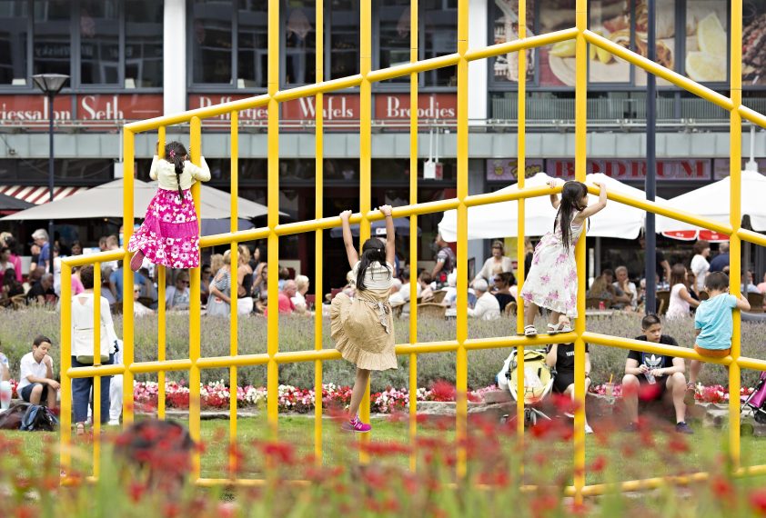 Children playing in the park in front of the Market Hall.