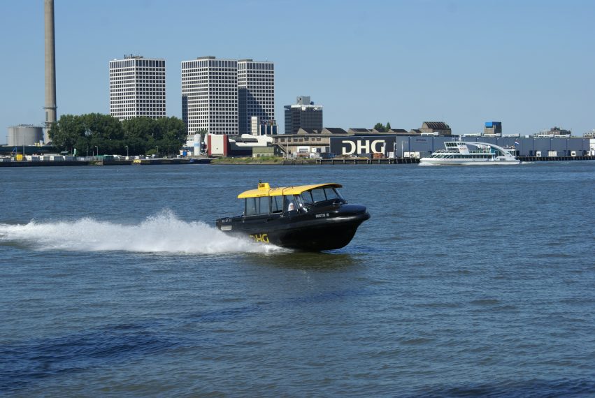 Watertaxi sails in the direction of RDM Rotterdam, Rotterdam Science Tower visible in the background