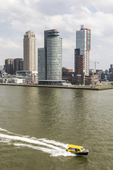 Water taxi passes the Kop van Zuid. 