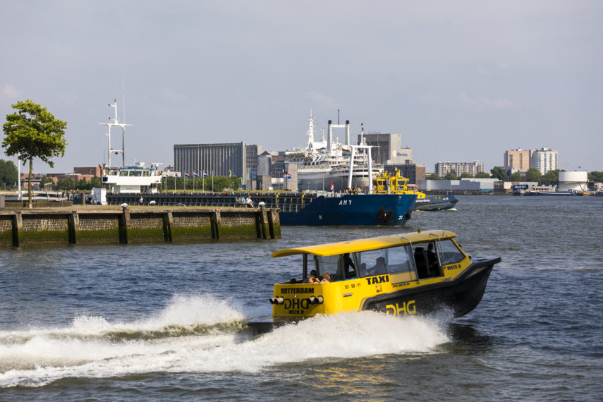 Watertaxi leaves the harbour near the ss Rotterdam.