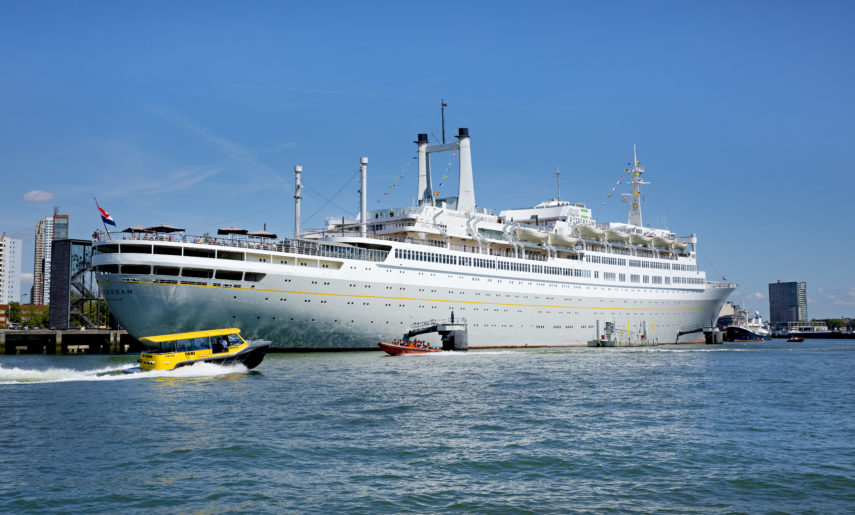 The water taxi sails past the ss Rotterdam.
