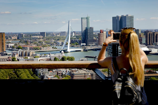 Woman takes a picture of the view from the Euromast.