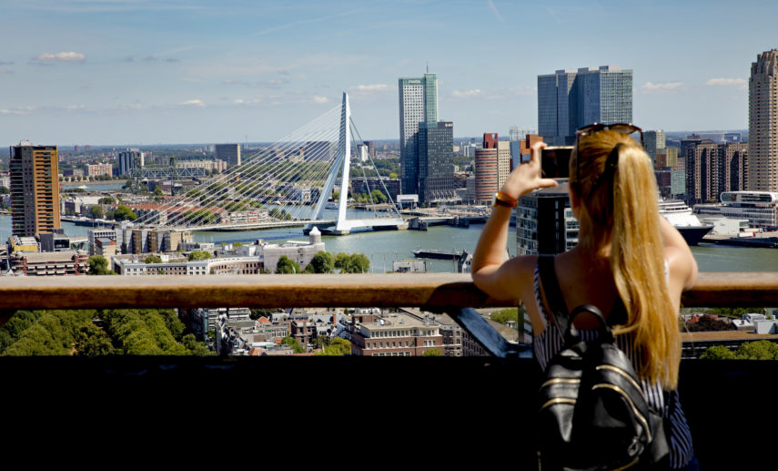 Woman takes a picture of the view from the Euromast.