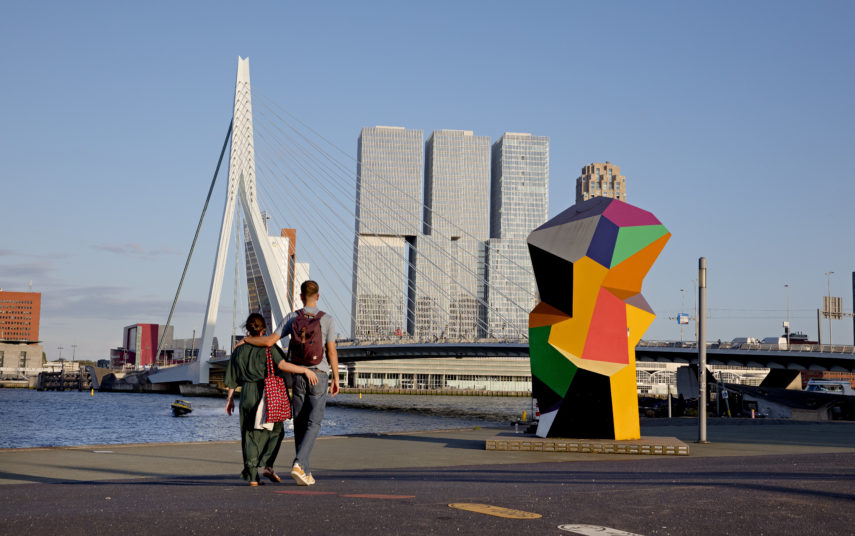 Couple walks along the river Maas.