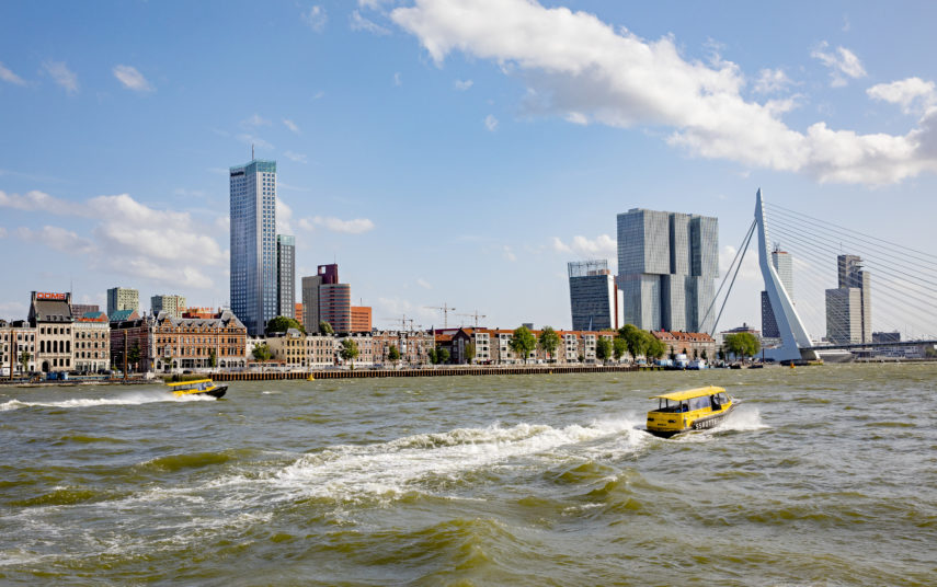 Water taxis sail over the Maas river.