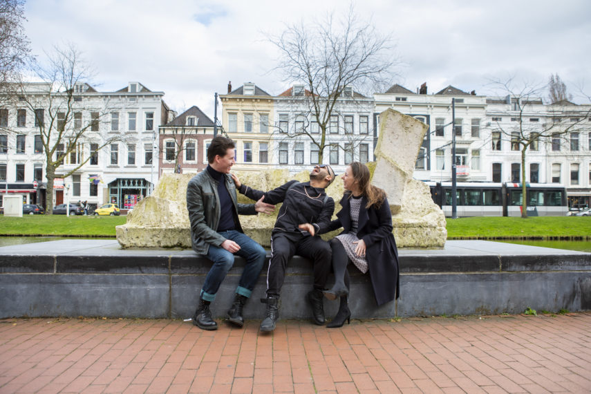 People sitting in front of sculpture by Fritz Wotruba.