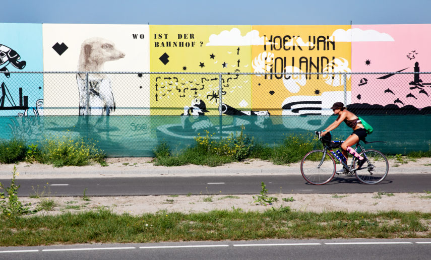 Biker in front of street art in Hoek van Holland.