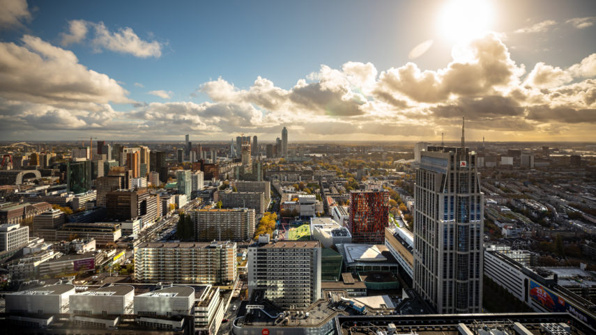 Beautiful skyline of Rotterdam with the sun behind the clouds.
