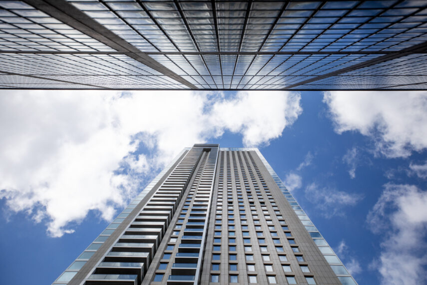 Artistic close up shot of the Zalmhaventorens complex. The Zalmhaven, also known as the Zalmhaventorens, is a recent addition to the skyline of Rotterdam and the tallest building in the Netherlands. You will find this complex of three residential towers, which was completed in 2022, at the foot of the Erasmus Bridge, on the north side of the Maas. The highest point is at 215 meters. The complex contains apartments, penthouses, townhouses, a parking garage, offices, commercial spaces and a restaurant. The complex was designed by Dam & Partners Architecten (Zalmhaven I, the tallest tower) and KAAN Architecten (Zalmhaven II and III towers).